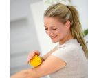 Femme pratiquant l'auto-massage avec une balles hérisson SISSEL® SPIKY BALL 8 cm jaune